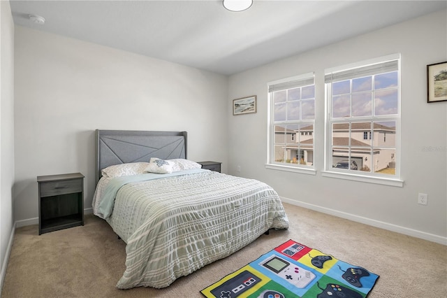 bedroom featuring carpet and baseboards