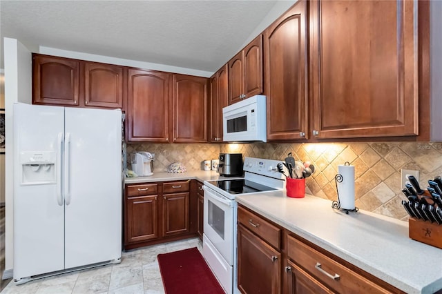 kitchen featuring tasteful backsplash, white appliances, light countertops, and a textured ceiling