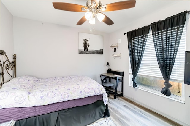 bedroom with a ceiling fan and light wood-type flooring