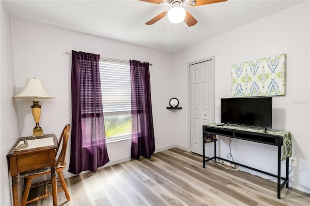 office area featuring a ceiling fan, baseboards, and wood finished floors