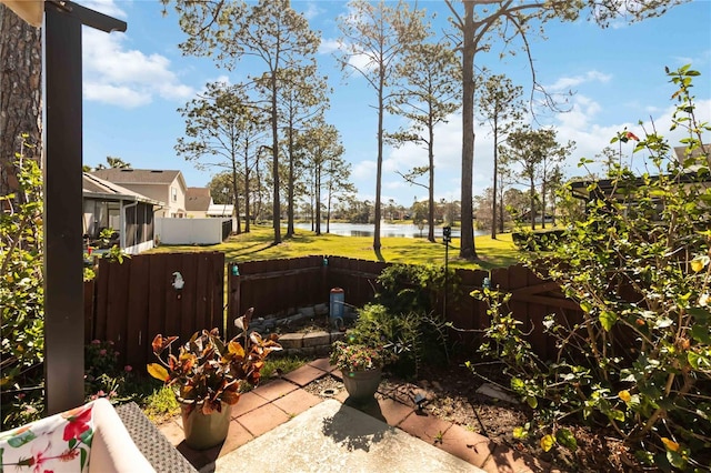 view of yard with a water view and fence