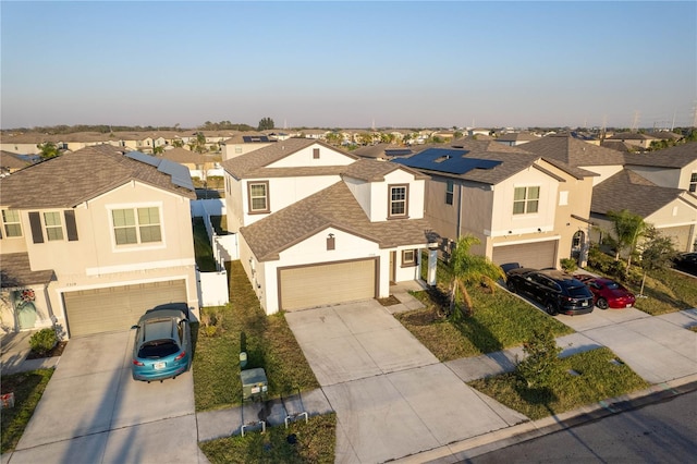 view of front of property featuring a garage, a shingled roof, concrete driveway, a residential view, and stucco siding