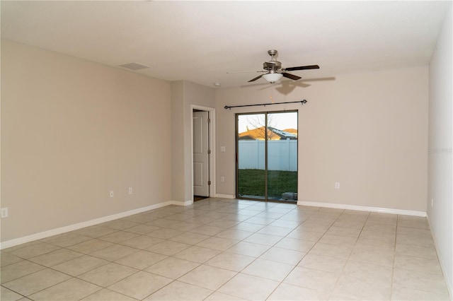 unfurnished room with a ceiling fan, visible vents, baseboards, and light tile patterned floors