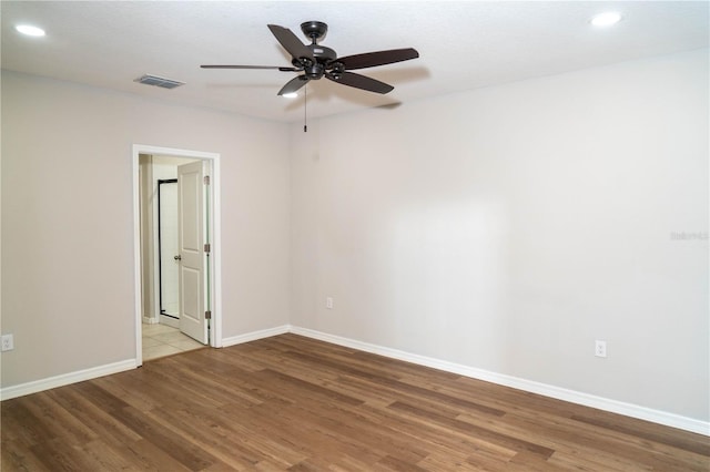 unfurnished room featuring baseboards, visible vents, ceiling fan, light wood-type flooring, and recessed lighting