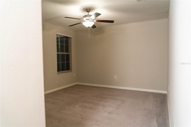 unfurnished room with ceiling fan, a textured ceiling, carpet flooring, and baseboards