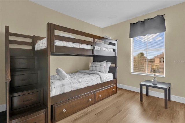 bedroom featuring light wood-style flooring and baseboards