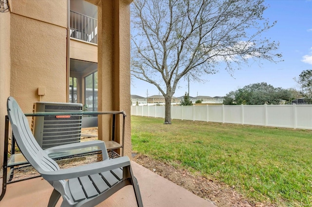 view of yard with cooling unit and fence