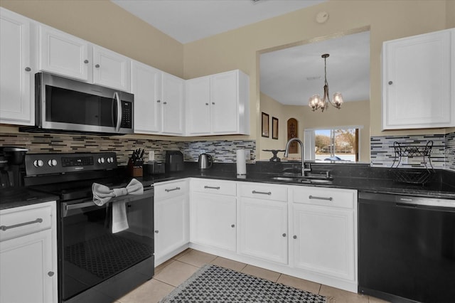 kitchen featuring dark countertops, white cabinetry, a sink, and black appliances