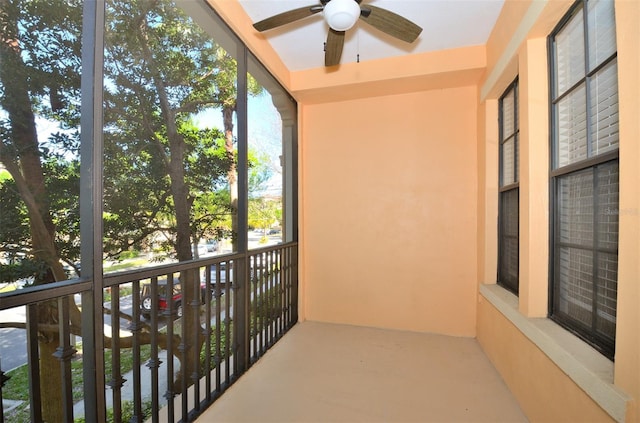 unfurnished sunroom featuring ceiling fan