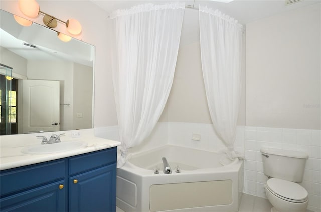 bathroom with visible vents, toilet, a bath, vanity, and tile walls