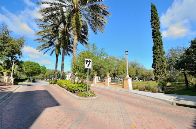 view of street featuring street lighting and curbs