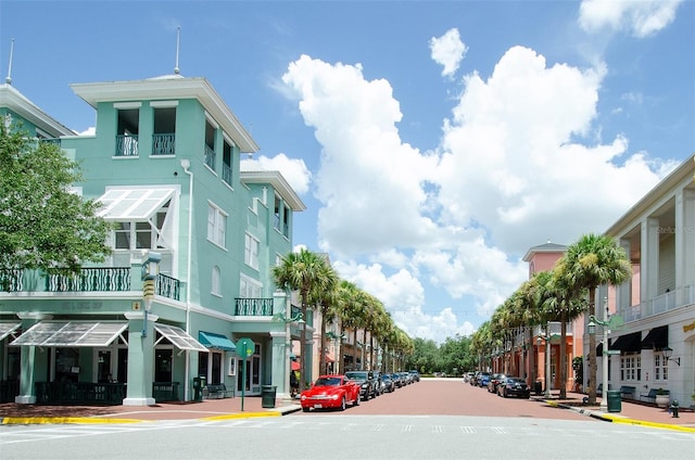 view of road with street lights, curbs, and sidewalks