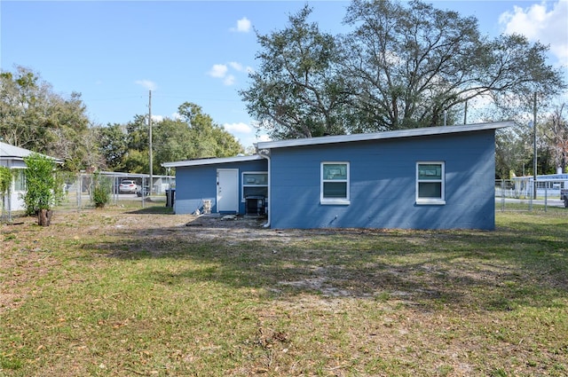 1006 San Domingo Rd, Orlando, FL 32808 - rear view of property featuring concrete block siding, a yard, and fence