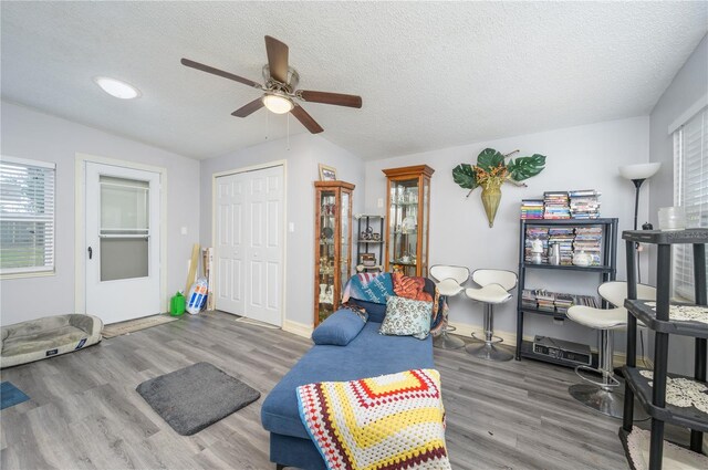1006 San Domingo Rd, Orlando, FL 32808 - living room with ceiling fan, a textured ceiling, baseboards, and wood finished floors