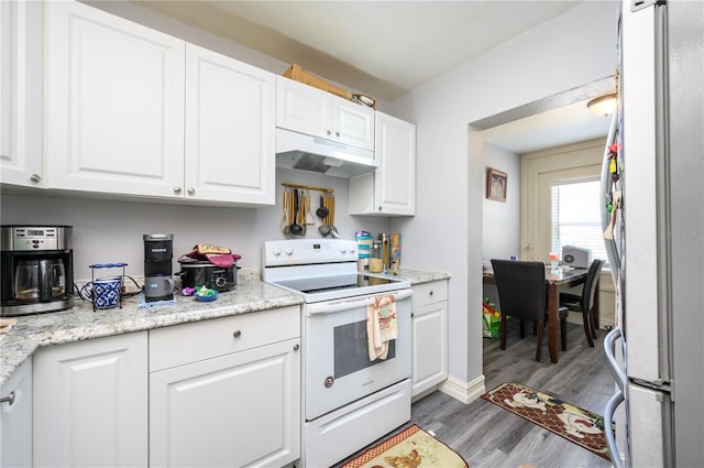 1006 San Domingo Rd, Orlando, FL 32808 - kitchen with white cabinets, freestanding refrigerator, white range with electric stovetop, and under cabinet range hood