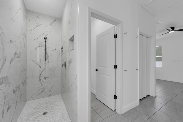 bathroom featuring baseboards and a marble finish shower