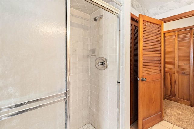 full bathroom with a closet and a shower stall