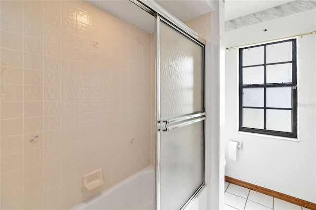 full bathroom featuring enclosed tub / shower combo, baseboards, and tile patterned floors