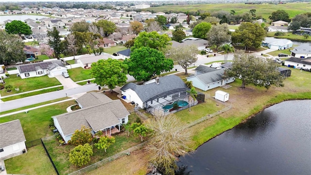 birds eye view of property with a water view and a residential view