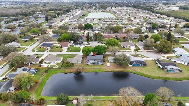 birds eye view of property with a residential view and a water view