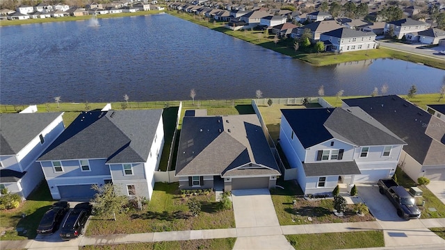 bird's eye view featuring a water view and a residential view