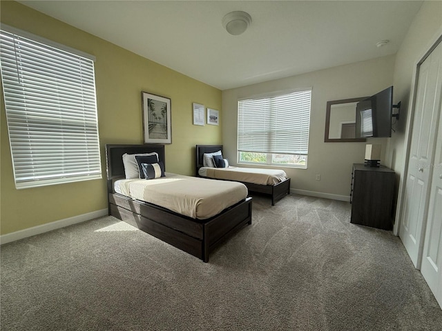 bedroom with light carpet and baseboards