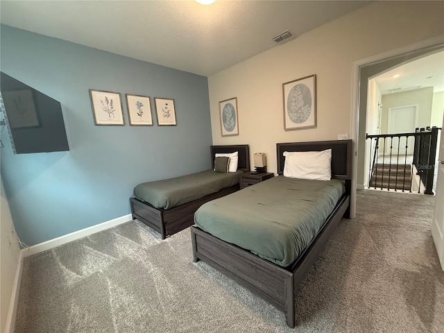 carpeted bedroom with visible vents and baseboards