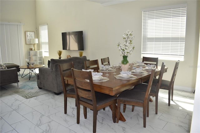 dining room featuring marble finish floor and baseboards