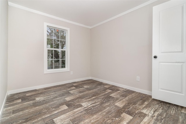 empty room featuring ornamental molding, dark wood finished floors, and baseboards