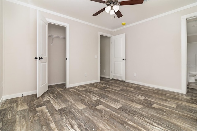 unfurnished bedroom with ensuite bath, baseboards, ornamental molding, and dark wood-type flooring