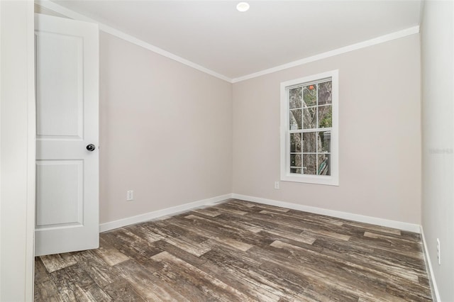 spare room with dark wood-style floors, baseboards, and crown molding