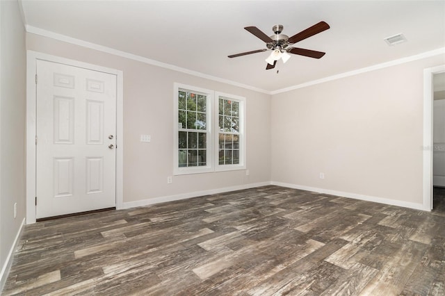 empty room with dark wood-type flooring, visible vents, and crown molding