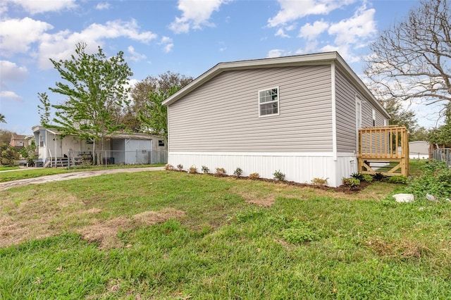 view of side of home with a lawn