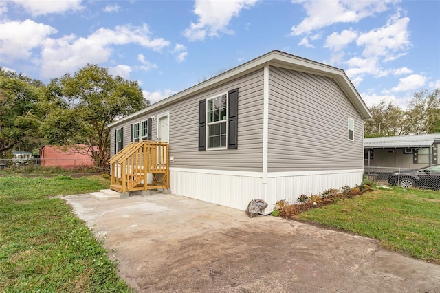 view of front facade with a front yard, a patio, and fence