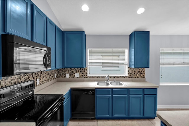 923 Tramells Trl, Kissimmee, FL 34744 - kitchen featuring blue cabinetry, light countertops, a sink, plenty of natural light, and black appliances