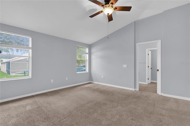 923 Tramells Trl, Kissimmee, FL 34744 - empty room with light carpet, vaulted ceiling, a ceiling fan, and baseboards