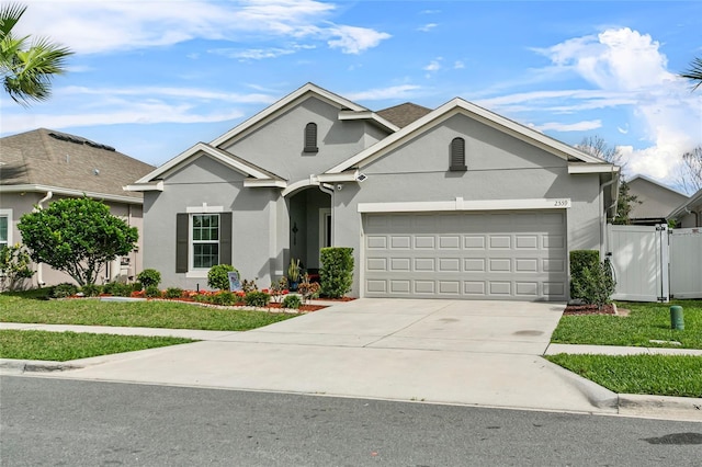 single story home featuring a garage, concrete driveway, a front lawn, and stucco siding