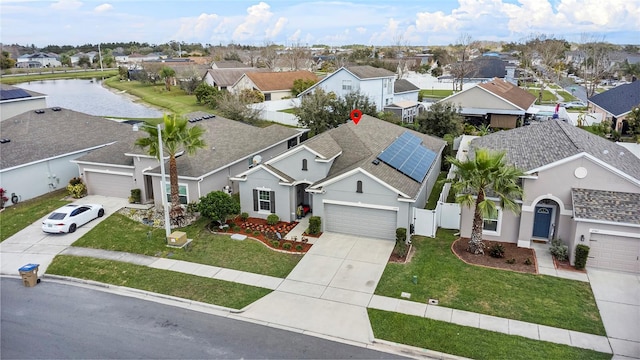 birds eye view of property featuring a water view and a residential view