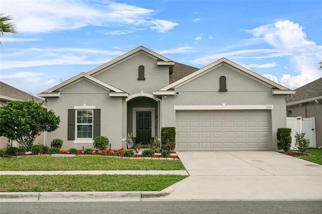 ranch-style house featuring driveway, an attached garage, and stucco siding