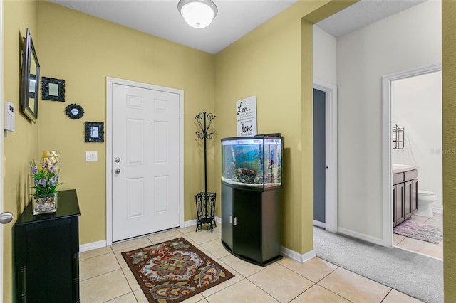 entryway featuring light tile patterned flooring and baseboards