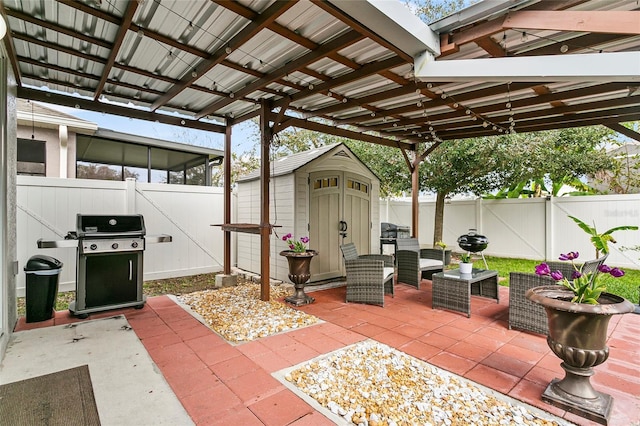 view of patio with a fenced backyard, an outdoor structure, an outdoor living space, grilling area, and a storage unit