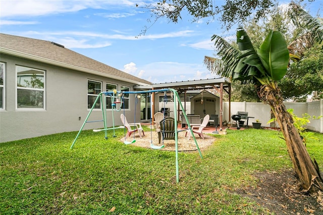 view of yard featuring an outbuilding, a fenced backyard, a playground, and a storage shed