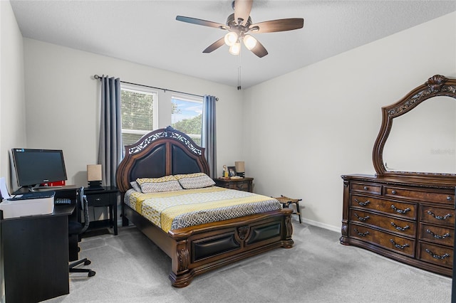 carpeted bedroom featuring a ceiling fan and baseboards