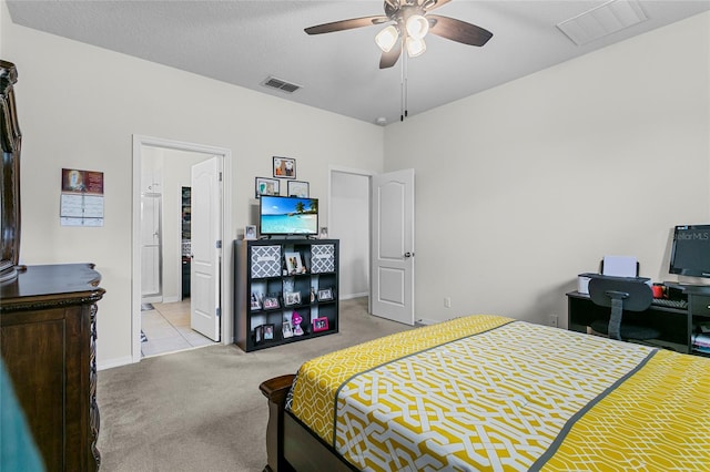 bedroom featuring baseboards, visible vents, a textured ceiling, and light colored carpet