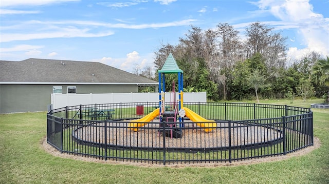 community playground featuring a lawn and fence