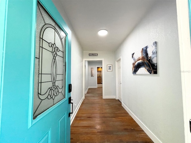 hall featuring dark wood finished floors and baseboards