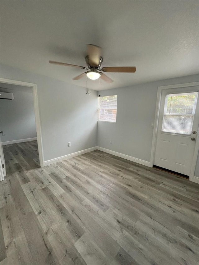 interior space featuring light wood-style flooring and baseboards