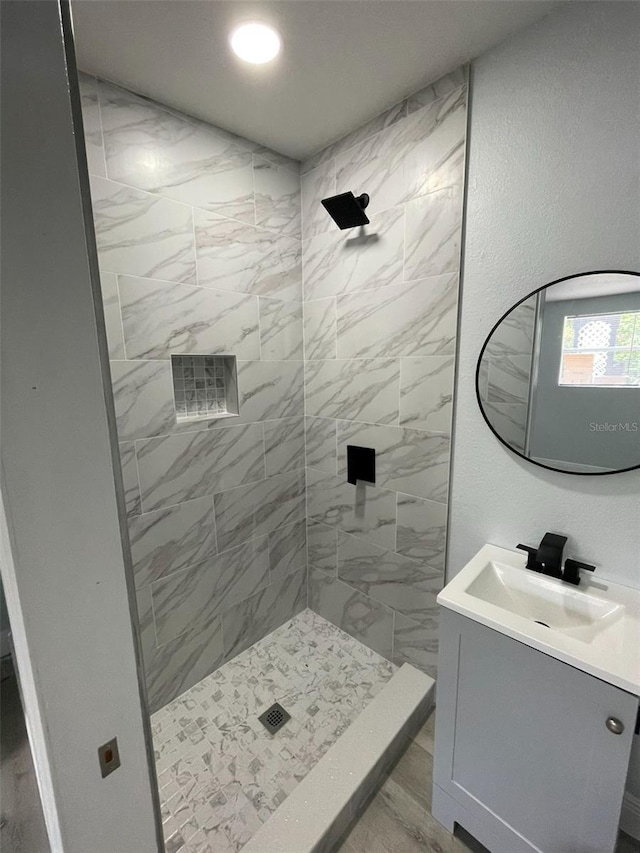 bathroom with recessed lighting, a shower stall, and vanity