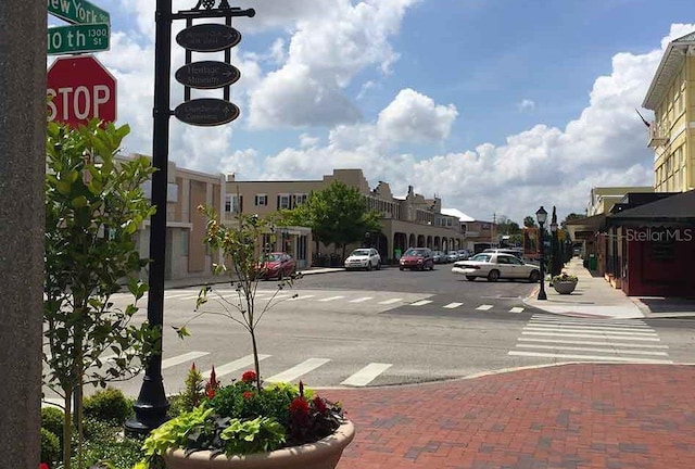 view of street with street lights, curbs, and sidewalks