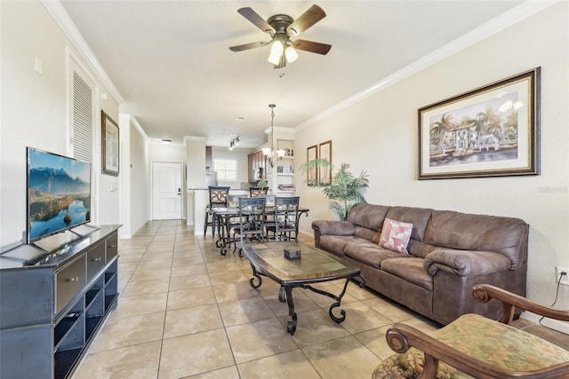 living room with light tile patterned floors, a ceiling fan, and crown molding